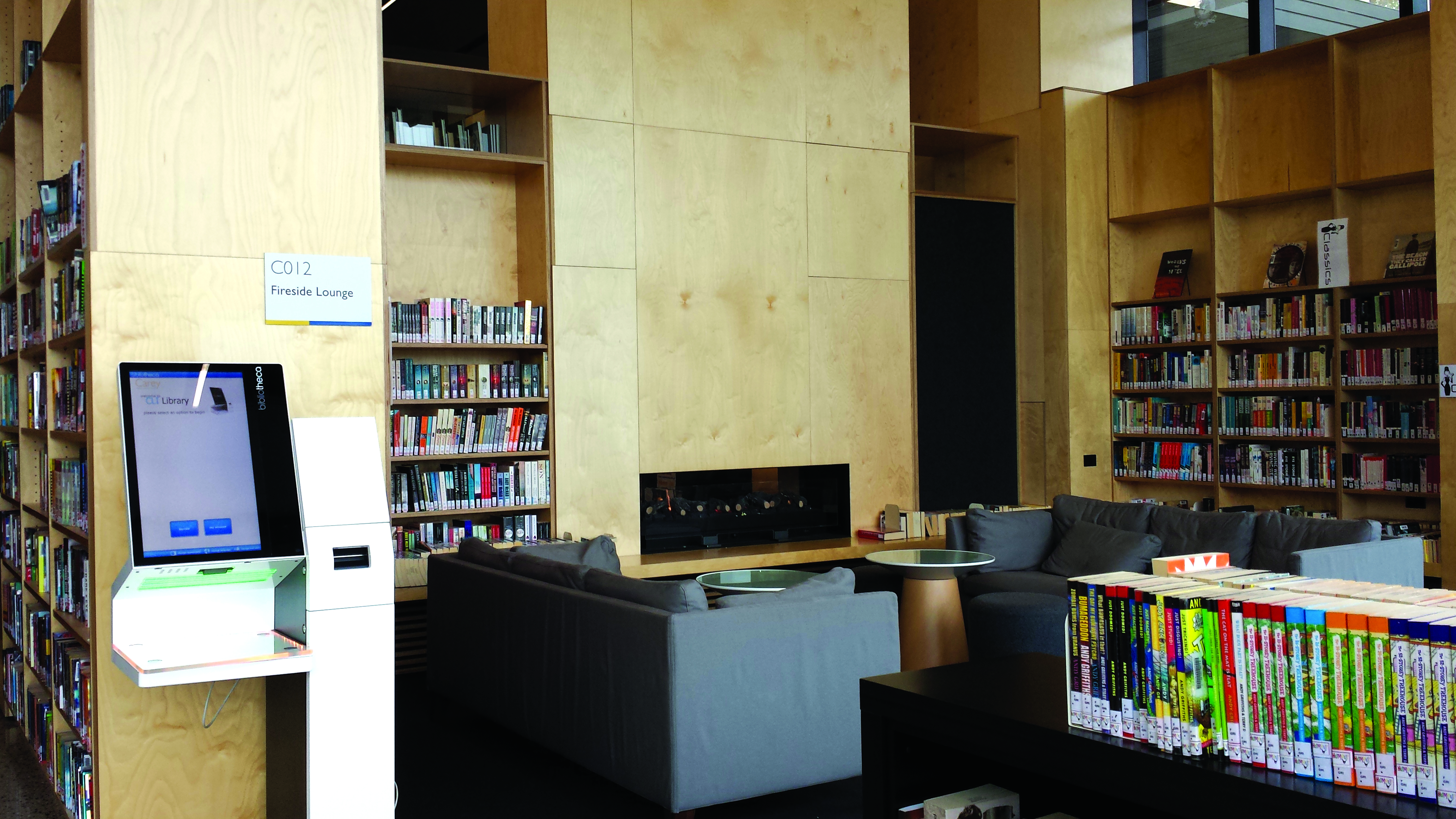 Lounges in front of a fireplace at one of the Casey Baptist Grammar College Libraries